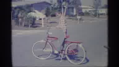 Indiana (1959): Boy Stands On His New Shiny Red Bicycle With Kickstand Down In