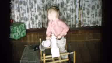 Michigan (1959): Young Child Plays With His Rocking Hothouse