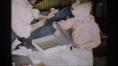 Michigan (1959): Boy Wearing Pink Shirt Looks At Blue And Red Striped Shirt