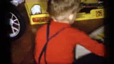 Michigan (1959): Child In Red Opens Up His Gifts On Christmas