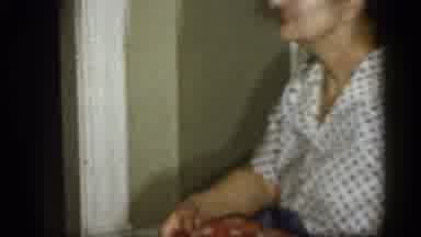 Michigan (1959): Old Grandma Unwrapping Cloth That Covers Bared