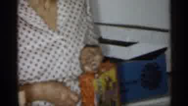 Michigan (1959): Woman Playing With Toy With Child In Red Oneness Leaching Father