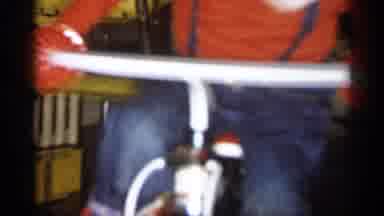 Michigan (1959): Boy In Red Shirt And Blue Overfills Rides Bike In House During