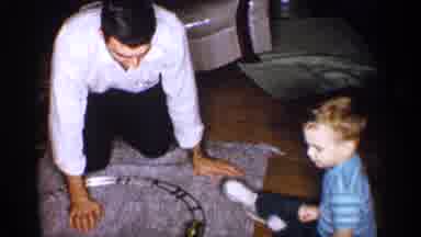Michigan (1959): Father Playing With Miniature Train With His Son At Home