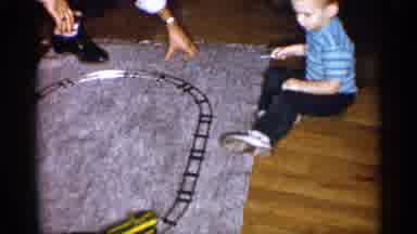 Michigan (1959): Young Boy Watching Toy Train Running Round Circular Truck