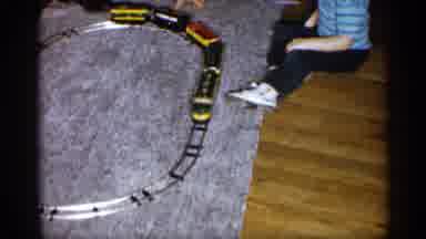Michigan (1959): Child Wearing Blue Shirt Plays With Toy Train On Blue Carpet Etch