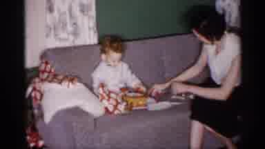 Michigan (1959): Father Turning A Object On Mir Cleaning Up Wrapping Paper Baby