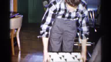 Michigan (1959): Man Wearing Grey Ants Opens Green And White Gift Box