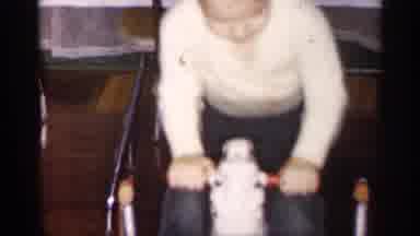 Michigan (1959): Child Wearing White Shirt Bounces On White Toy Rocking Horse
