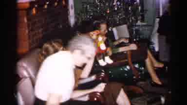 Michigan (1959): Young Woman Plays With Toy Monkey As Child Sits On The Trike In