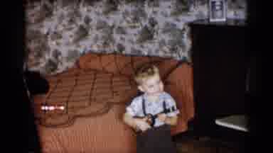 Michigan (1959): Child Playing A Small Guitar While Another Child Dances And An