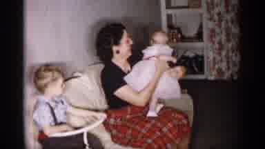 Michigan (1959): Woman Wearing Black Shirt Shows Baby's Red And White Bloomers