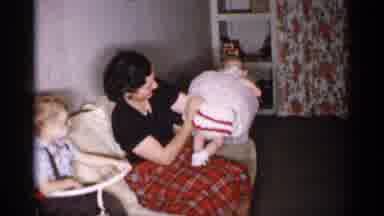 Michigan (1959): A Woman Is Holding A Baby Girl In The Room Are 2 Other Women And