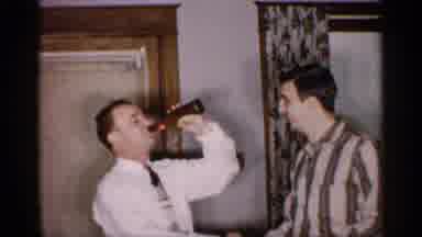 Michigan (1959): Two Men Shaking Hands And Sharing A Beer In What Looks Like