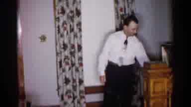 Michigan (1959): Man And Several Children In Living Room Near Stairs Then Man