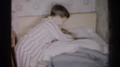 Michigan-1959: Boy Wearing Striped Pajamas Kisses Parents Goodnight