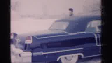 Michigan (1959): An Elegant Man Wearing A Suit Gets Into His Beautiful Blue Car