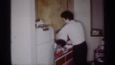 Michigan (1959): Woman Washing The Dishes While His Son Plays In The Living Room