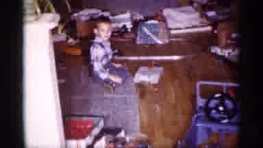 Michigan (1959): Boy Wearing Blue Pants Plays With Electric Toy Train By Christmas