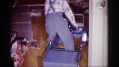 Michigan (1959): Old Footage Child Stepping Inside Blue Play Toy Car In Living