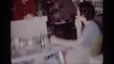Michigan (1959): Indoor Video Showing A Woman Smoking And A Man Holding A Child In