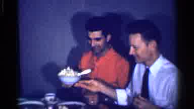 Michigan (1959): Man Wearing Orange Shirt Spoons Mashed Potatoes From Light Blue
