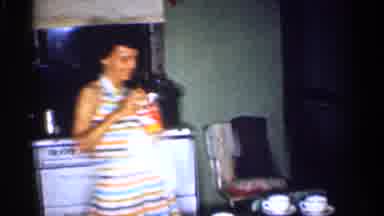 Michigan (1959): A Smiling Woman Stands Over A Table In A Kitchen And Opens A Jar