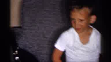 Michigan (1959): Woman Wearing White Shirt Holds A Baby Wearing White Shirt