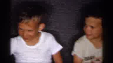 Michigan (1959): Four Boys Sit On Grey Sofa Laughing With Man Wearing White Shirt
