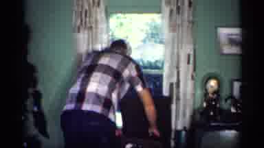 Michigan (1959): Relaxed Man Flipping A Record In His Home Filled With Life