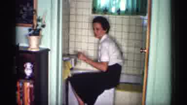 Michigan (1959): A Women Looks Over And Washes Her Bathtub In Her Bathroom