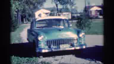 Michigan (1959): Three Cars Parked In The Driveway Sit Quietly As The Camera