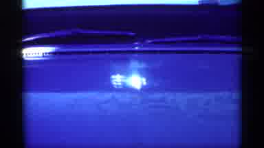 Michigan (1959): Light Reflects Off The Hood Of A Car Parked Outside Followed By A