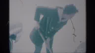New York (1959): Woman Wearing Winter Coat Uses Shovel Out Of Frame In Grainy