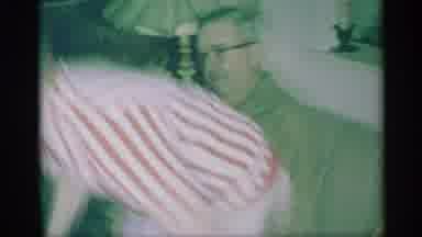 New York (1959): Child Gets Up From Parents Side To Get Christmas Present With