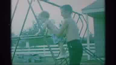 New York (1959): A Kind Brother Helping His Sibling To Enjoy A Swing Set