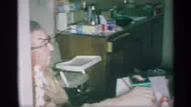 New York (1959): Elderly Man With Glasses Sitting In Kitchen With A High Chair In