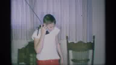 New York (1959): Boy Talks On Walkies Talkie Inside Home While Young Child Plays
