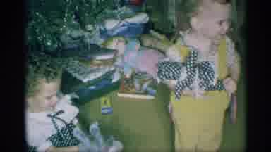 New York (1959): Two Toddlers Stand Next To Trimmed Christmas Tree Holding Toys