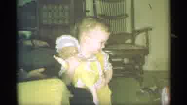 New York (1959): A Child With A Doll With Two Adults Sitting On A Winter Day
