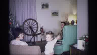 New York (1959): Boy Wearing Red Pants And Man Sitting In Green Chair Wave To
