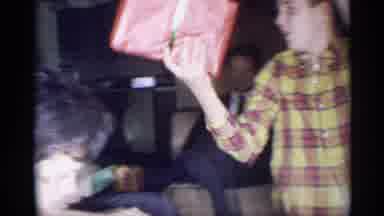 New York (1959): A Happy Family At Christmas Time Exchanging Gifts In Excitement