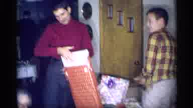 New York (1959): A Family Members Enjoys Their Surprise Gift And Very Happy