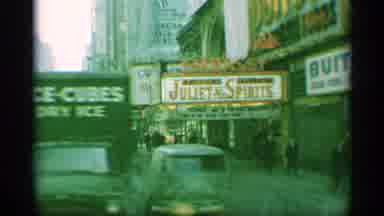 New York (1959): Entertain Center In A Downtown Area With People Walking Around