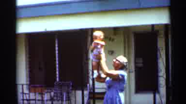 Mississippi (1963): A Person Holding Up A Little Girl In The Air Outside In Front