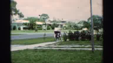 Mississippi (1963): Man On A Bike Riding Around The Neighborhood