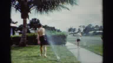 Mississippi (1963): A Family Kids Are Playing In The Lawn Area With The Water