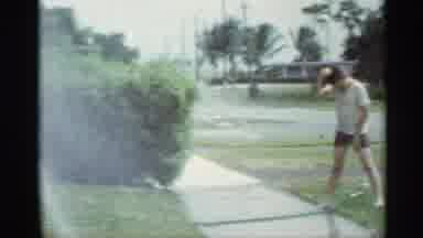 Mississippi (1963): Woman Waves To Camera That Pans To Child In Sprinkler