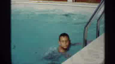 Mississippi (1963): Child In Bathing Suit Slides Down Slide Into Pool In Backyard