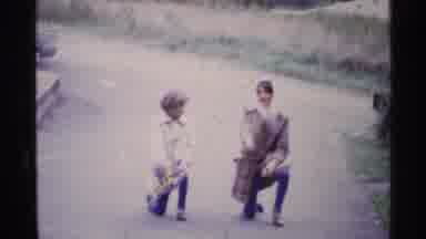 Ohio USA (1969): Mother And Son Doing A Cheering Routine On The Sidewalk Having